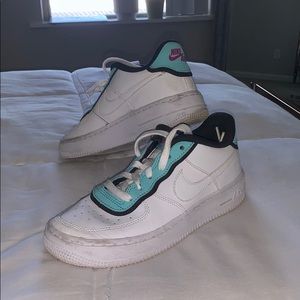 Nike Air white and teal sneakers.